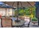 Covered outdoor patio with comfortable seating overlooking a gorgeous pool with a waterfall feature at 3358 Fernlake Pl, Longwood, FL 32779