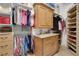 Well-organized walk-in closet with built-in shelves, cabinets, and ample storage space for clothes and accessories at 3358 Fernlake Pl, Longwood, FL 32779