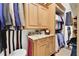 Organized walk-in closet with custom cabinetry, shelving, and storage for suits, ties, and shirts at 3358 Fernlake Pl, Longwood, FL 32779