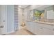 The bathroom features a walk in shower and double sink vanity at 33601 Seattle Slew Dr, Sorrento, FL 32776