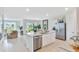 Open-concept kitchen with a large island, stainless steel appliances, and abundant natural light at 33601 Seattle Slew Dr, Sorrento, FL 32776