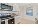 Well-appointed kitchen featuring stainless steel appliances, granite countertops, and ample storage at 33601 Seattle Slew Dr, Sorrento, FL 32776