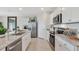 Modern kitchen with granite countertops, stainless steel appliances, and white cabinetry at 33601 Seattle Slew Dr, Sorrento, FL 32776