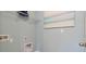 Functional laundry room with wall-mounted shelving and utility connections, perfect for convenience at 33601 Seattle Slew Dr, Sorrento, FL 32776