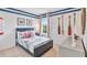 A bedroom featuring nautical-themed decor, complemented by bright, natural light from the window at 33605 Seattle Slew Dr, Sorrento, FL 32776