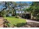 A large backyard featuring a well-maintained lawn and an outdoor patio area at 3407 Pershing Ave, Orlando, FL 32812