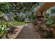 Serene backyard featuring a brick walkway and lush greenery, perfect for relaxing and enjoying the outdoors at 3407 Pershing Ave, Orlando, FL 32812