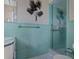 A tiled bathroom featuring a glass shower and a decorative piece of wall art at 3407 Pershing Ave, Orlando, FL 32812