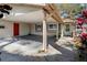 Attached covered two-car carport on this charming home with a red door at 3407 Pershing Ave, Orlando, FL 32812