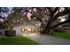Charming home with a large tree in front of the house and a covered two-car carport at 3407 Pershing Ave, Orlando, FL 32812