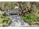 Charming single-story home with lush landscaping and mature tree in the front yard at 3407 Pershing Ave, Orlando, FL 32812
