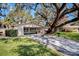 Charming home with large tree in front and a covered two-car carport at 3407 Pershing Ave, Orlando, FL 32812