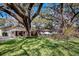Charming single-story home with lush landscaping and a mature tree in the front yard at 3407 Pershing Ave, Orlando, FL 32812