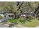 Charming single-story home with lush landscaping and a large mature tree in the front yard at 3407 Pershing Ave, Orlando, FL 32812