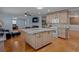 Open-concept kitchen with large island, custom cabinets, and access to living spaces at 3407 Pershing Ave, Orlando, FL 32812