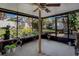The covered outdoor patio with views of the backyard, and potted plants at 3407 Pershing Ave, Orlando, FL 32812