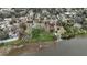 Waterfront property with lush greenery, private dock access, and marked boundaries, offering endless possibilities at 3540 Walker Rd, Apopka, FL 32703