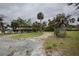 Home exterior featuring a sprawling lot with mature landscaping and a circular drive at 3540 Walker Rd, Apopka, FL 32703