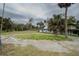 Exterior shows lot with lush landscaping, mature palm trees, and circular drive at 3540 Walker Rd, Apopka, FL 32703