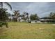 Exterior home view featuring spacious lot with lush landscaping and a circular drive at 3540 Walker Rd, Apopka, FL 32703