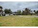 Two-story house surrounded by expansive green lawn, large trees, a separate outbuilding and long driveway at 3540 Walker Rd, Apopka, FL 32703