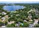 Wide aerial view showcasing the home's proximity to a large lake and lush green surroundings at 5646 Spring Run Ave, Orlando, FL 32819