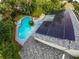 Aerial view of the home displaying solar panels, a backyard pool, and a well-maintained roof at 5646 Spring Run Ave, Orlando, FL 32819