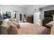Spacious bedroom showcasing warm terra cotta flooring, a large closet, and direct access to the ensuite bathroom at 5646 Spring Run Ave, Orlando, FL 32819