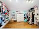 Walk-in closet with hardwood floors, plentiful shelves and clothing racks, and ample storage at 5646 Spring Run Ave, Orlando, FL 32819