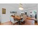 Dining room with hardwood floors, a wooden table, and a view of an open concept kitchen perfect for entertaining at 5646 Spring Run Ave, Orlando, FL 32819