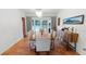 Dining room with hardwood floors, a large wooden table, and chairs, creating an inviting space for meals and gatherings at 5646 Spring Run Ave, Orlando, FL 32819
