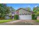 Charming two-story home with a well-maintained lawn and a two-car garage at 5646 Spring Run Ave, Orlando, FL 32819