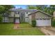 Beautiful home showcasing a lush green lawn and a brick-accented two-car garage at 5646 Spring Run Ave, Orlando, FL 32819