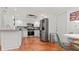 Modern kitchen with stainless steel appliances, white cabinets, and brick-tile flooring at 5646 Spring Run Ave, Orlando, FL 32819