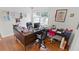 Office with wood floors, a large desk, multiple chairs and bright natural light at 5646 Spring Run Ave, Orlando, FL 32819
