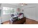 Bright office featuring hardwood floors, a ceiling fan, closet, and a large window at 5646 Spring Run Ave, Orlando, FL 32819