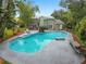 Backyard showcasing a large in-ground pool, mature trees, and a seating area perfect for relaxing and entertaining outdoors at 5646 Spring Run Ave, Orlando, FL 32819