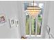 Staircase with a stylish chandelier and a large window bringing natural light in to brighten the space at 5646 Spring Run Ave, Orlando, FL 32819
