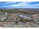 A high aerial showcases condos with a lake and community pool nestled in trees at 5766 Lesabre Dr, Kissimmee, FL 34746