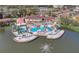 Overhead shot showcasing the resort's clubhouse and pool area on the lake, complete with a waterslide and expansive decking at 5766 Lesabre Dr, Kissimmee, FL 34746