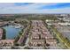 Aerial view of community featuring condominium buildings, swimming pool, and lake at 5766 Lesabre Dr, Kissimmee, FL 34746