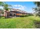 Townhome complex with enclosed patio, green grass, and mature trees offering privacy and scenic views at 5766 Lesabre Dr, Kissimmee, FL 34746