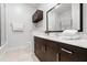 Bathroom features a spacious vanity with dark brown cabinetry, white countertops, and a glass-enclosed shower at 5766 Lesabre Dr, Kissimmee, FL 34746