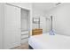 This bedroom boasts a mounted flatscreen, carpeted floors, and a closet with shelving for ample storage at 5766 Lesabre Dr, Kissimmee, FL 34746