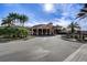 Elegant Regal Oaks clubhouse entrance with lush landscaping and palm trees at 5766 Lesabre Dr, Kissimmee, FL 34746