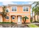 Charming two-story townhome with colorful exterior, well-manicured landscaping, and convenient parking at 5766 Lesabre Dr, Kissimmee, FL 34746