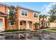 Beautiful two-story home with a tile roof, mature palms and a well-maintained lawn at 5766 Lesabre Dr, Kissimmee, FL 34746