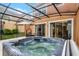 Covered patio with relaxing hot tub perfect for unwinding after a long day at 5766 Lesabre Dr, Kissimmee, FL 34746