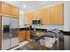 Close-up of the kitchen with stainless steel appliances and dark granite countertops at 5766 Lesabre Dr, Kissimmee, FL 34746