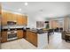 Open kitchen with stainless steel appliances, granite countertops, and bar seating leading to dining at 5766 Lesabre Dr, Kissimmee, FL 34746